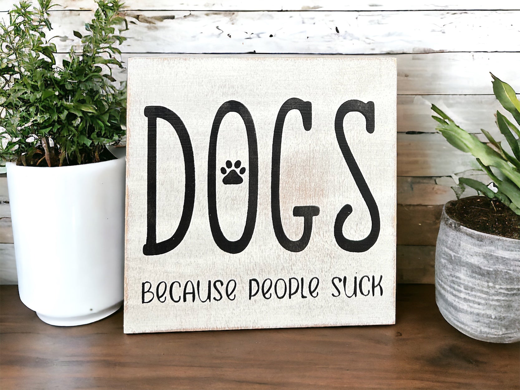 "Dogs because people suck" wood sign
