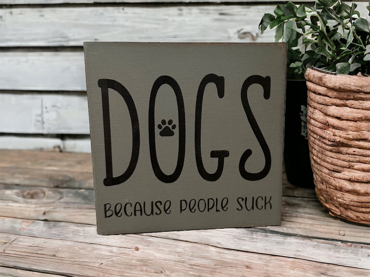 "Dogs because people suck" wood sign