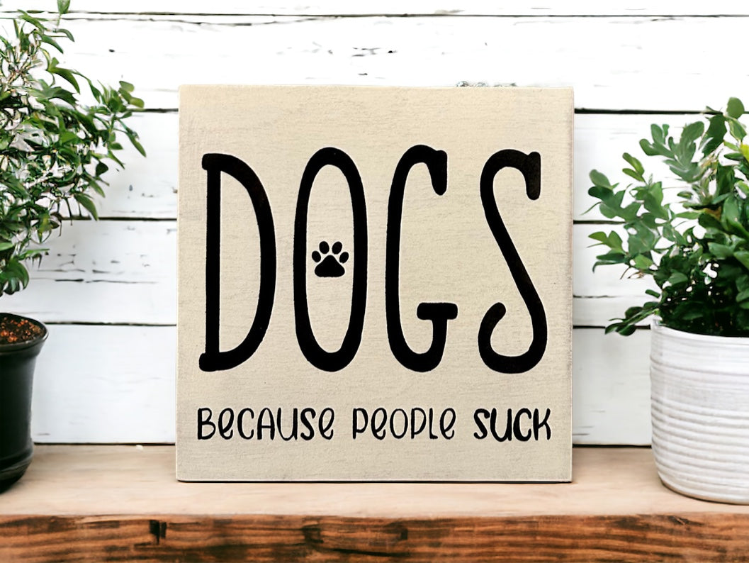 "Dogs because people suck" wood sign