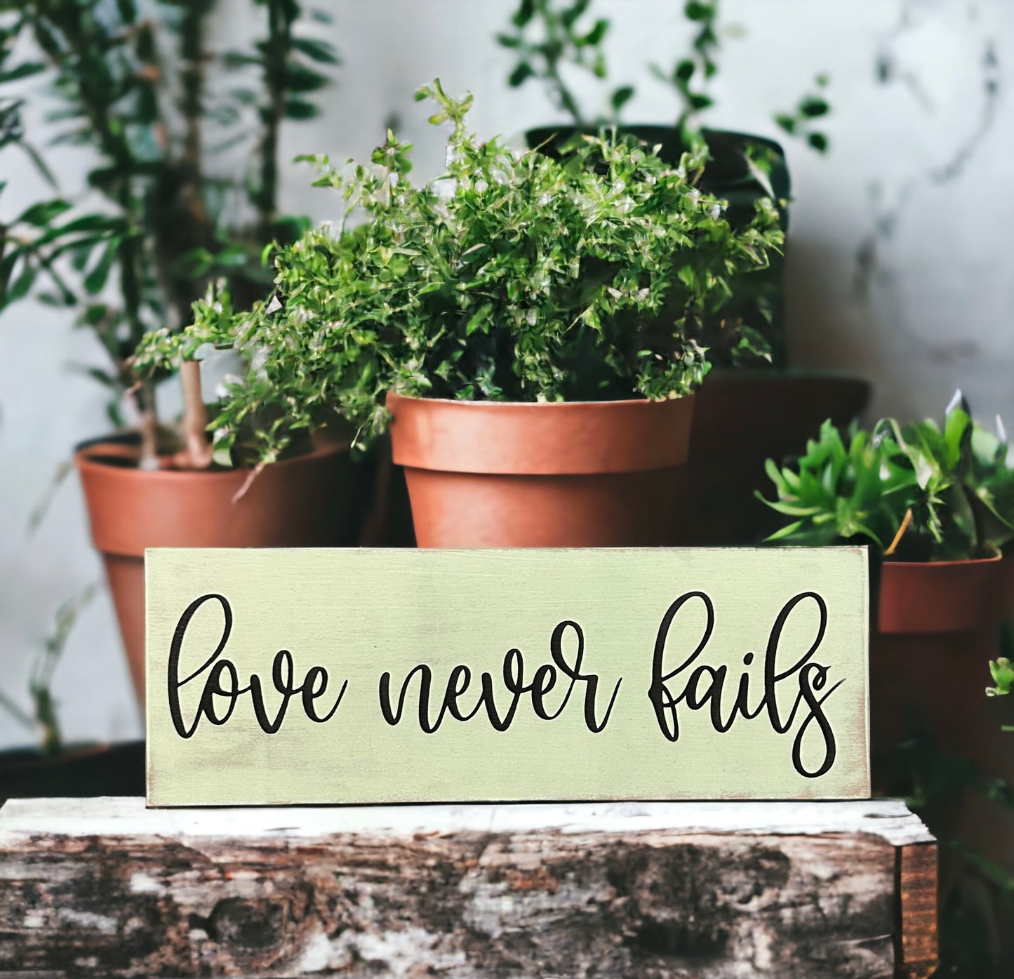 "Love never fails" wood sign