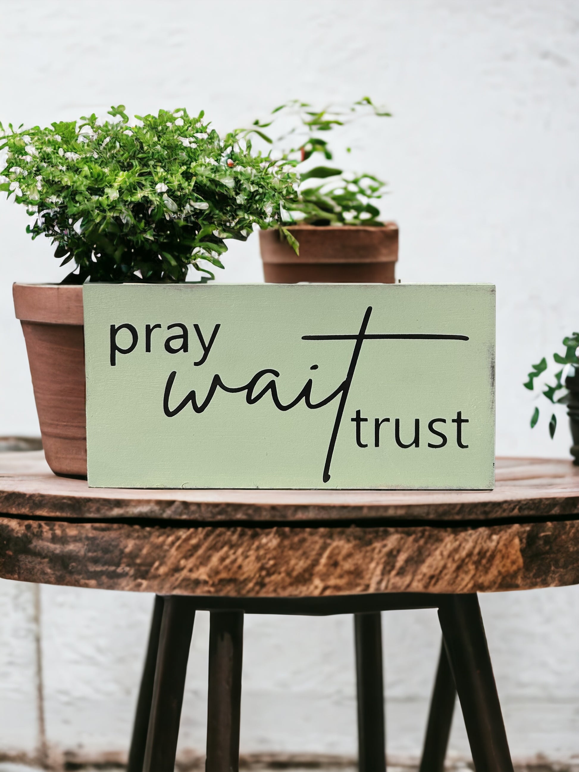 "Pray wait trust" wood sign