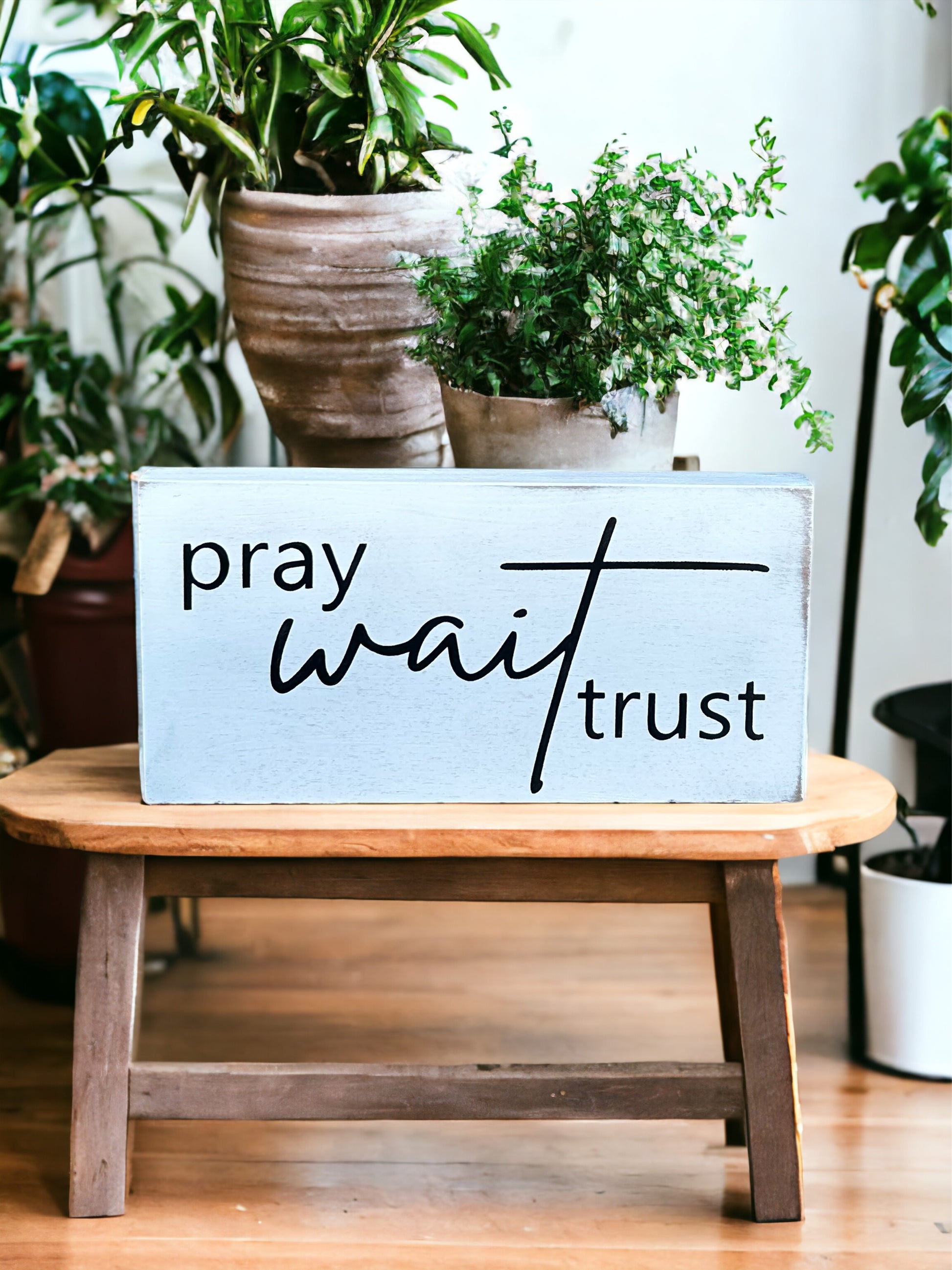 "Pray wait trust" wood sign