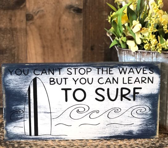 "Learn to surf" wood sign