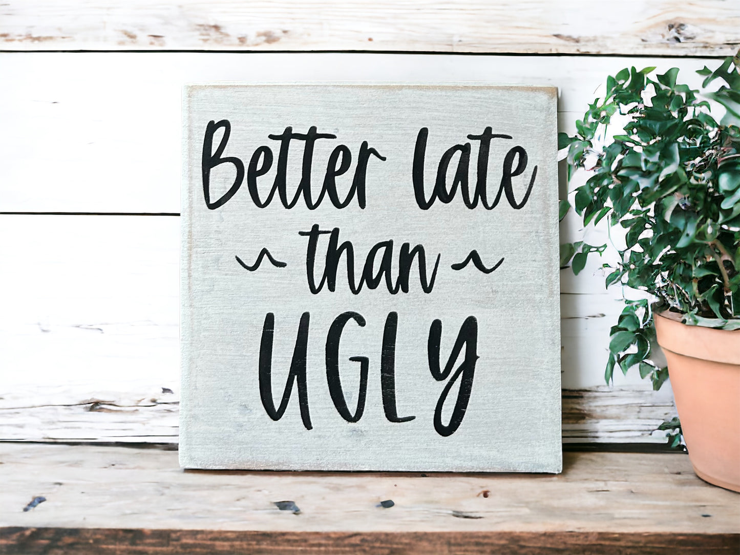 "Better late than ugly" wood sign