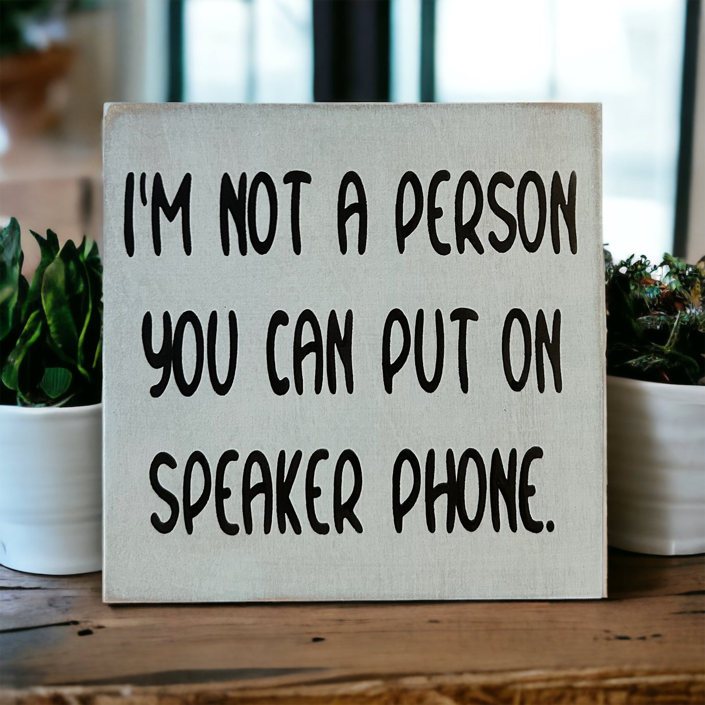 "not a person you can put on speakerphone" wood sign