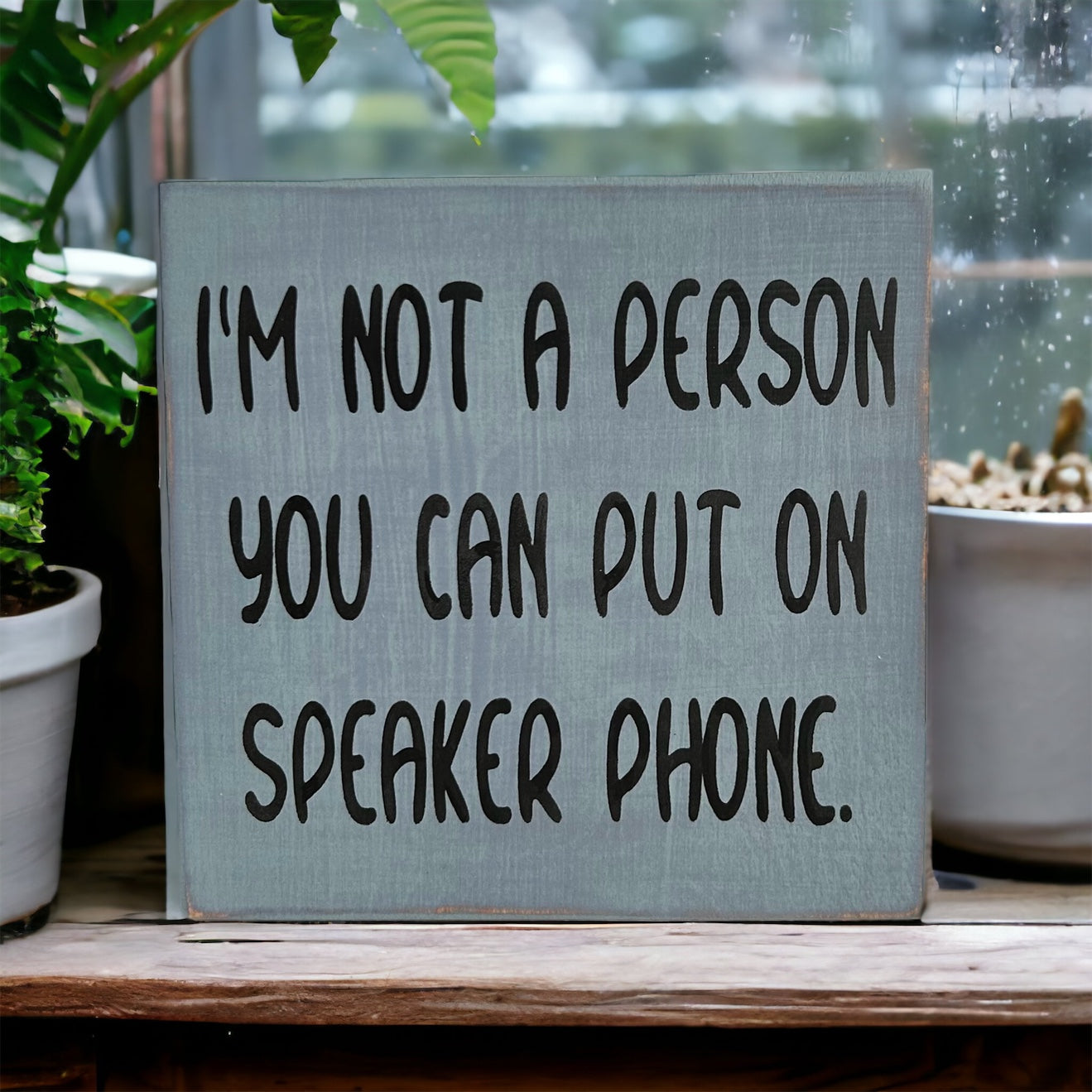 "Not a person you can put on speakerphone" wood sign