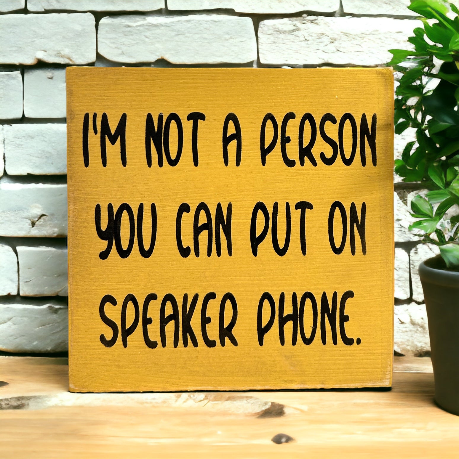 "I'm not a person you can put on speakerphone" wood sign