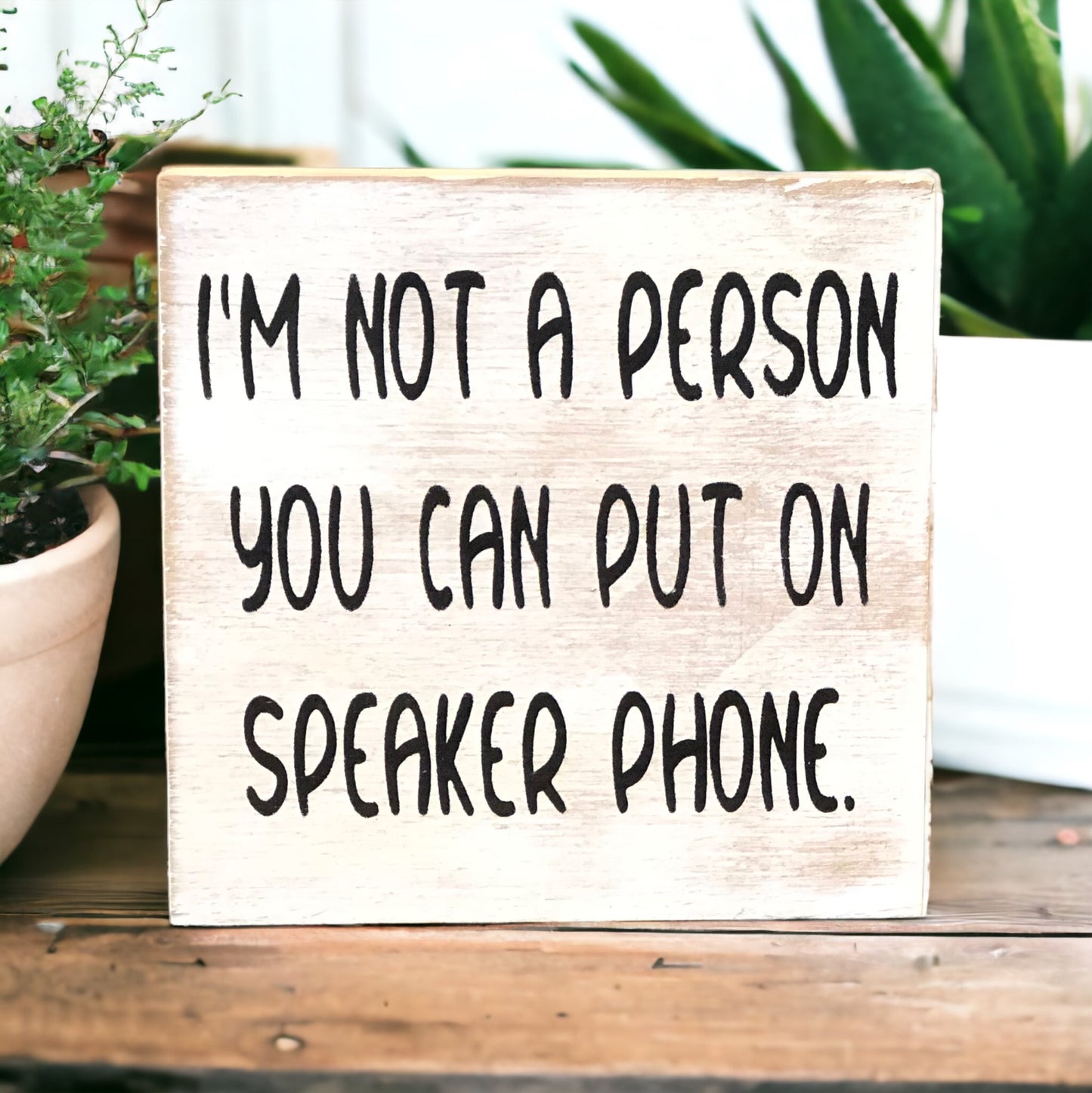 "I'm not a person you can put on speakerphone" wood sign