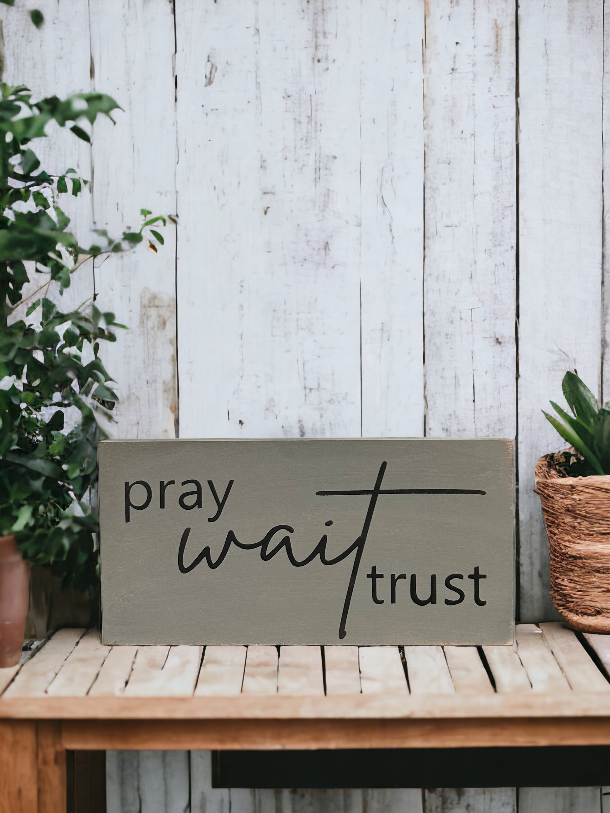 "Pray wait trust" wood sign