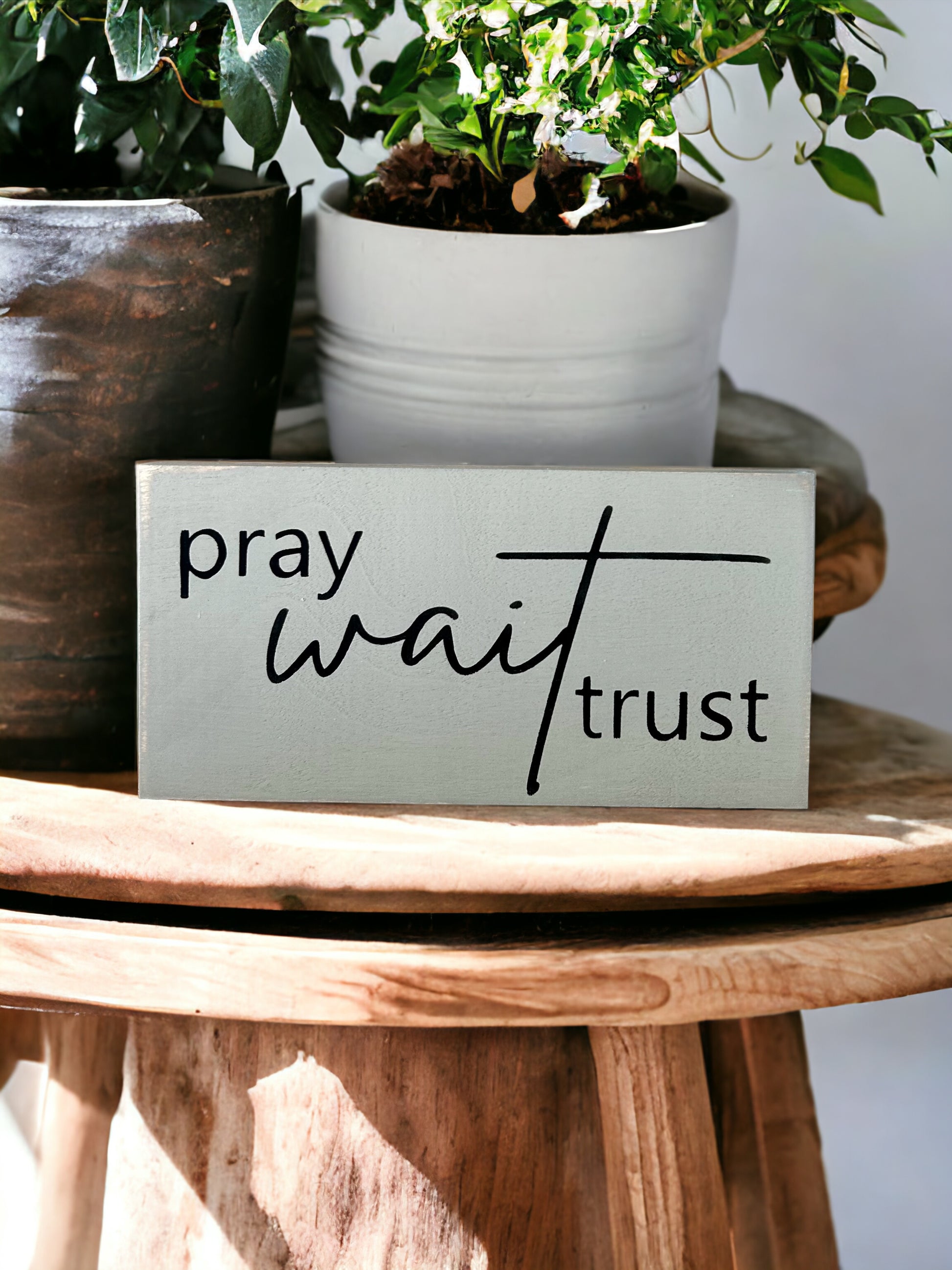 "Pray wait trust" wood sign